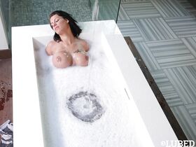 Busty brunette MILF Peta Jensen wetting naked body in bathtub