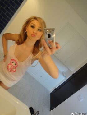 Cute blonde Molly Bennett takes selfies of her natural tits in the bathroom