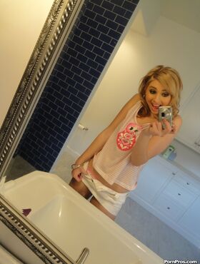 Cute blonde Molly Bennett takes selfies of her natural tits in the bathroom