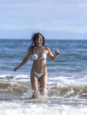 Athletic model Abbie Maley concludes a solo shoot with a romp in the ocean