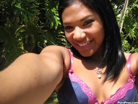 Smiling Latina babe Emy Reyes plays a clothed solo outdoors reveals hot curves