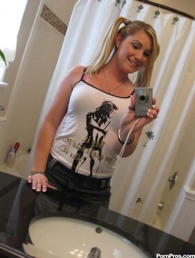 Blonde gf Hayden Night snaps selfies in bathroom while licking a lollipop