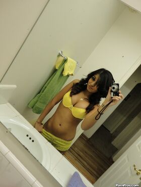 Brunette girlfriend type Ruby Reyes takes self shots on exposed boob in mirror