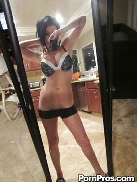 Dark haired babe Loni Evans snaps selfies while stripping in front of mirror