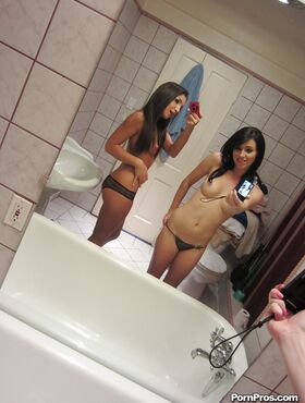 Lesbian beauties Giselle Leon and Megan Piper posing in a mirror