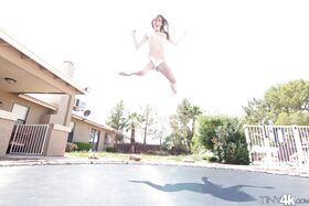 Leggy solo girl Lola Hunter poses outdoors beside swimming pool in bikini