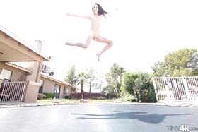 Leggy solo girl Lola Hunter poses outdoors beside swimming pool in bikini