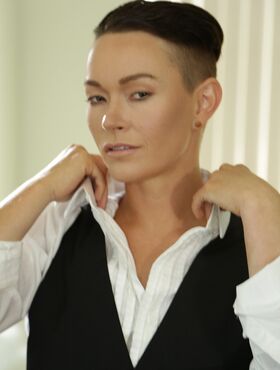 Androgynous short haired model Jiz Lee posing in her male outfit
