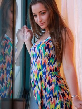 Dani Daniels takes off her colorful dress to show big ass and natural tits