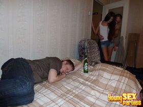 Teen girls have a 3some on a bed with a boy while another boy is passed out