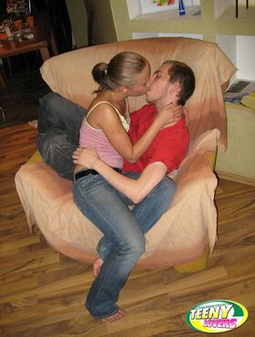 Horny teens make out while getting naked for a fuck on a comfy chair