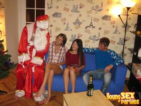 Teen girls commence a foursome fuck after Santa arrives on the scene