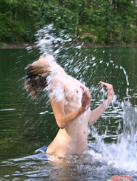 Slender Russian teen Zarina peels her bikini off and takes a bath in the river