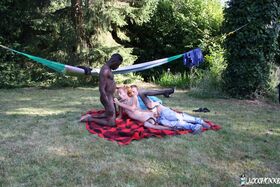 Skinny redhead gets hot double penetration in interracial outdoor threesome