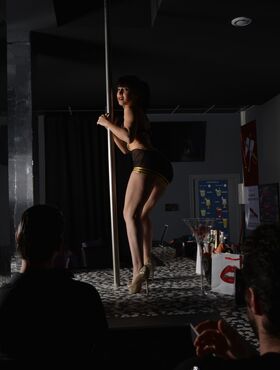 Hot French chick Yasmine seducing two guys while pole dancing and using dildo