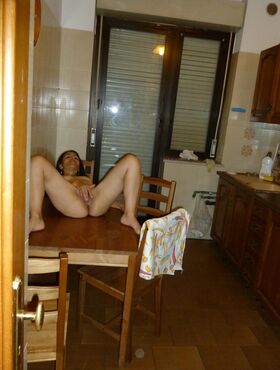 Naked mature amateur enjoys solo masturbation on the kitchen table
