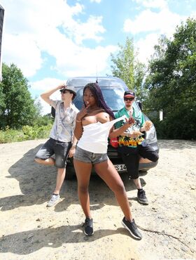 Ebony babe with round ass Sunny Star posing with her fuckers by the van