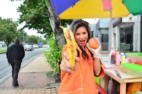 Beautiful Colombian fruit seller gestures provocatively with a banana