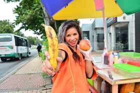 Beautiful Colombian fruit seller gestures provocatively with a banana