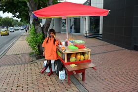 Beautiful Colombian fruit seller gestures provocatively with a banana