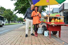 Beautiful Colombian fruit seller gestures provocatively with a banana