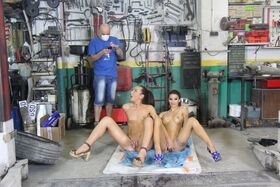Horny garage groupies strip down and oil up to spread ass on their knees