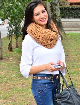 Attractive Latina Penelope Perez posing outside clothed in tight jeans & scarf