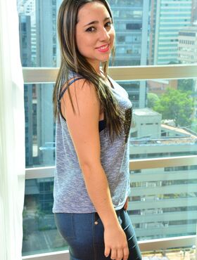 Enticing Latina beauty removes her jeans to show her big ass by the window