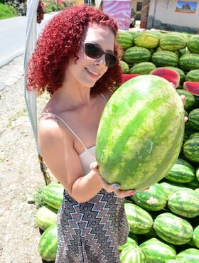 Curly redhead Latina with small tits & big clit gets nude to eat a melon