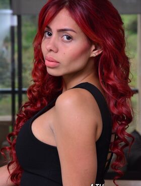 Beautiful redhead Latina Ivana Ramirez flips the bird while posing topless