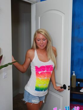 Alluring teenage blonde in jeans shorts getting naked in the massage parlor