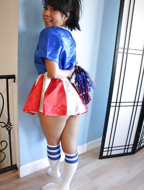 Tiny Asian cheerleader May Lee posing in cute uniform and socks