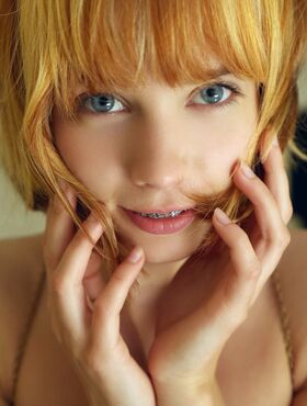 Adorable redhead Lily displays her young girl's body in the nude