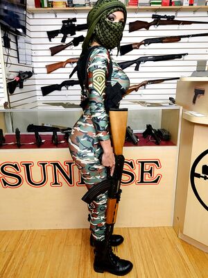 Money Talks - Camouflaged chick with rifle in hand lets her big natural breasts loose