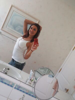 Disgraced 18 - Nasty brunette slut Nikka taking couple of selfies in the bathroom